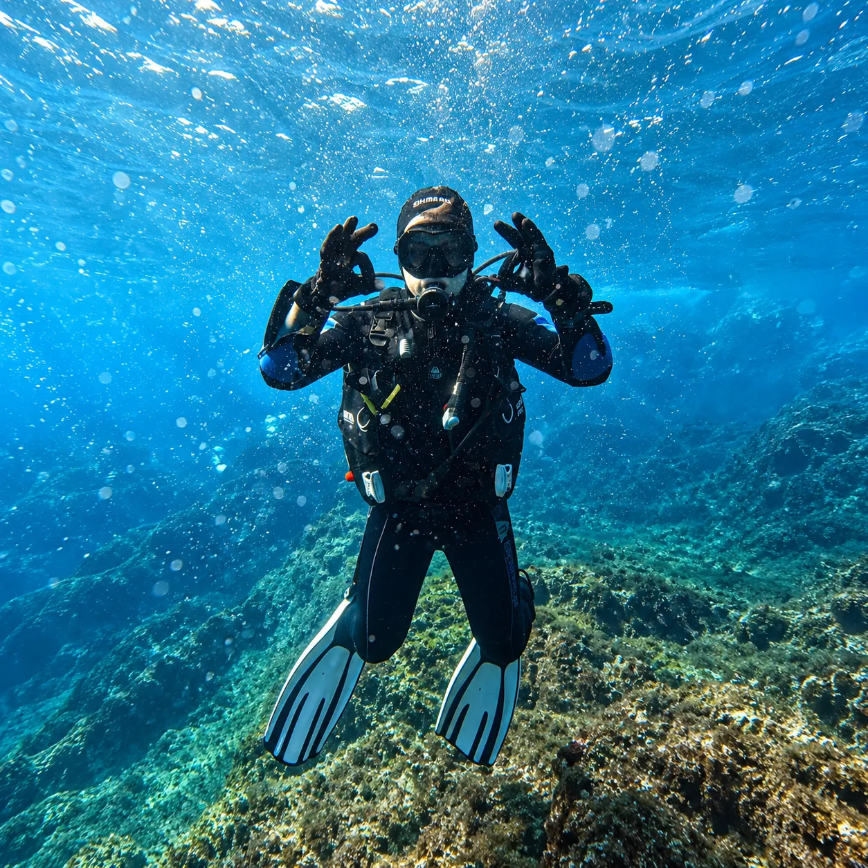 Scuba divers exploring coral reefs off coastal Karnataka